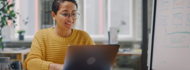 A businessperson looks at a laptop