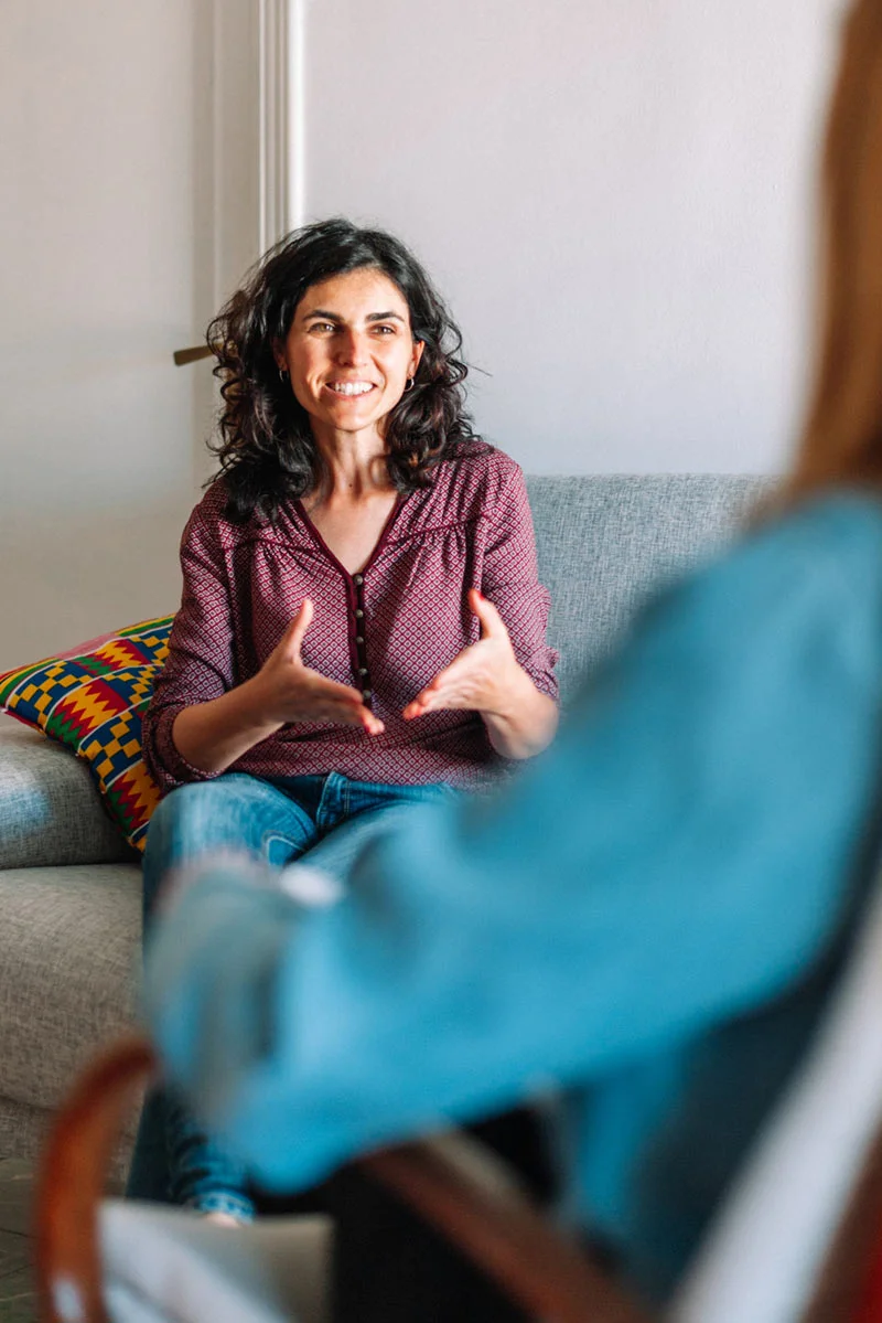 An person gestures to another person